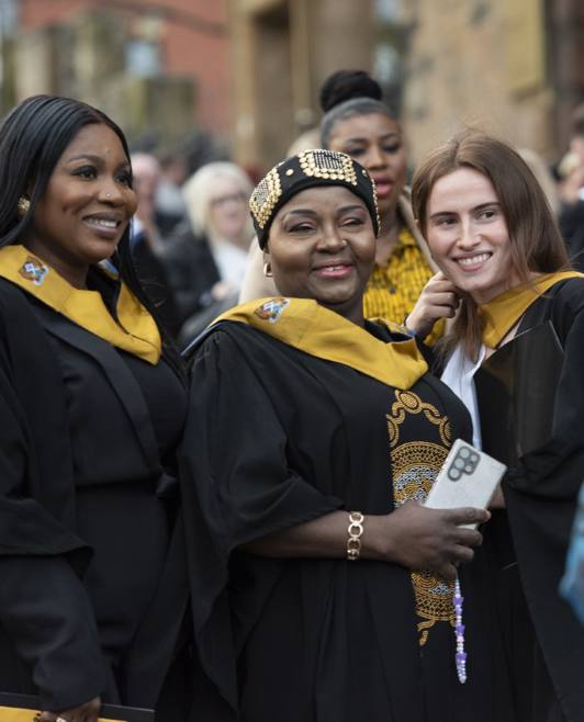 3 female graduates outside 3 female graduates outside